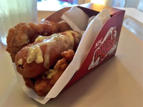 Images of the sandwich are creating a lot of feelings on the internet, though we'd probably still taste it if it was available in the u.s. KFC Double Down Dog Replaces Hot Dog Buns with Chicken