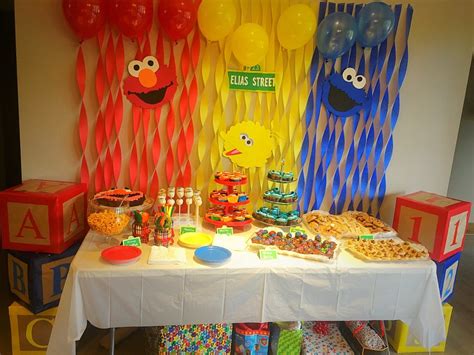 A sesame street inspired brunch party with a basic color palette of golden yellows, gray, and white. Sesame Street 1st Birthday Party - Kickin' It With Kim