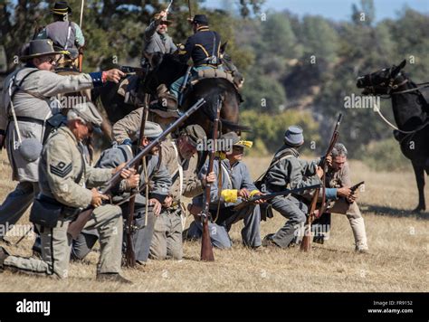 Confederate Soldiers In Action At An American Civil War Reenactment At
