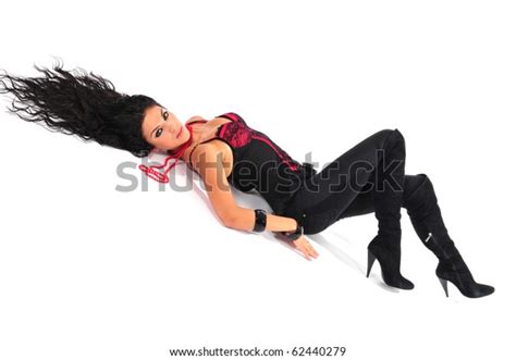 Sexy Brunette In Red Corset With Long Hair Spreading Out Lying Down On