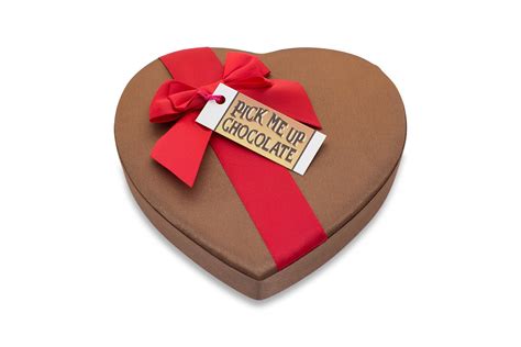Chocolates in heart shape box on brown wooden table. Chocolate Heart Box 13 pc - Pick Me Up Chocolate