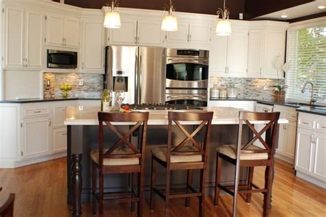 Stainless steel appliances add yet another layer of contrast making for a surprisingly cohesive whole. White Kitchen Cabinets with Stainless Steel Appliances - Home Furniture Design