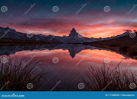 Sunset On Dem Matterhorn And Its Reflection In A Mountain Lake Stock