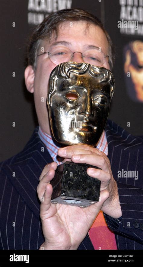 Actor Comedian And Writer Stephen Fry Holds A Bafta Award During A Photocall To Announce The
