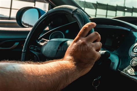 Driver S Hands On The Steering Wheel Inside Of A Car Stock Photo