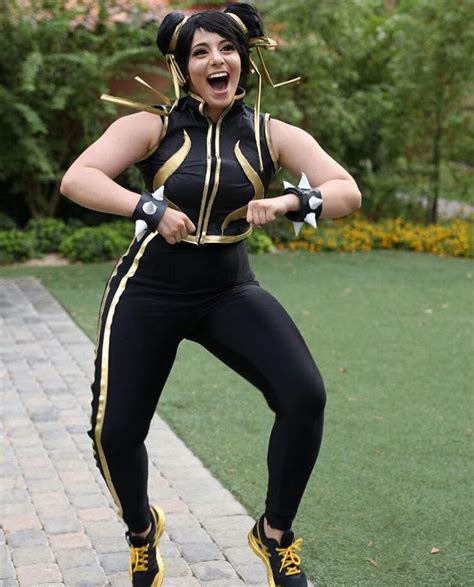A Woman In A Black And Gold Costume