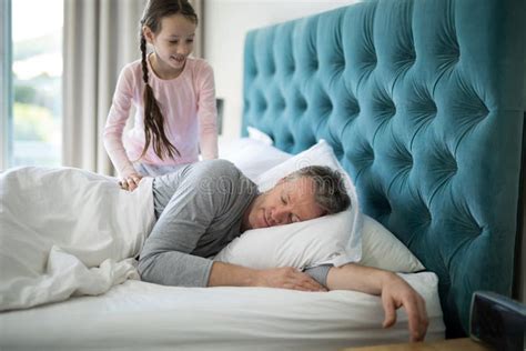 Girl Waking Her Sleeping Father Up In Bed Stock Photo Image Of