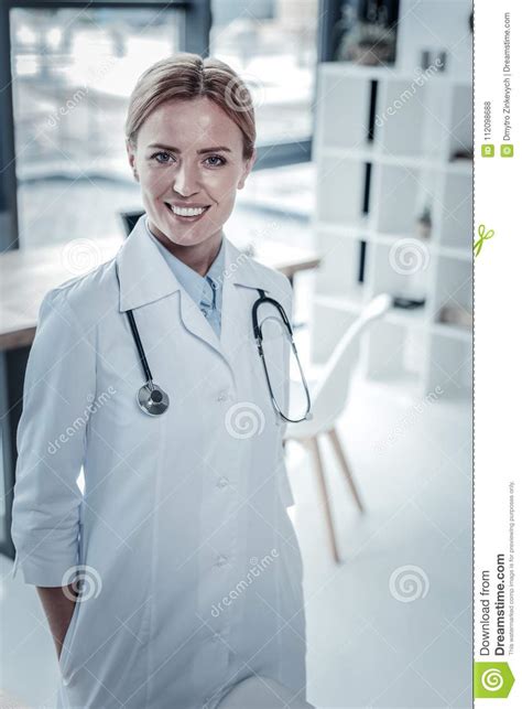 Cute Confident Nurse Standing And Smiling Stock Photo Image Of