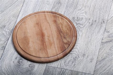Round Kitchen Wooden Board On A Dark Wooden Background Stock Photo