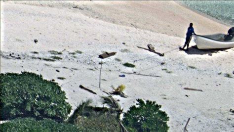 Photos Stranded Couple Rescued After Drawing Sos Message In Sand