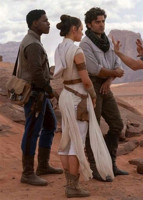 some people are standing in the desert and one is wearing a costume that looks like luke star wars