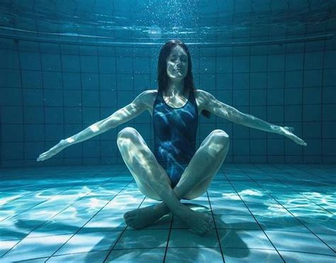 athletic swimmer smiling at camera underwater in the swimming pool at the leisure centre water