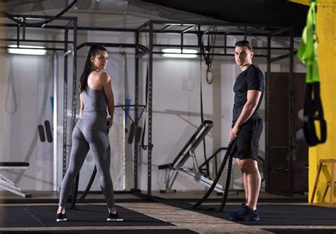 Premium Photo Young Fit Sports Couple Working Out In Functional