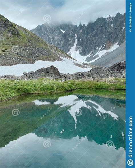 Mountain Lake With Turquoise Water And Mountain Range Stock Photo