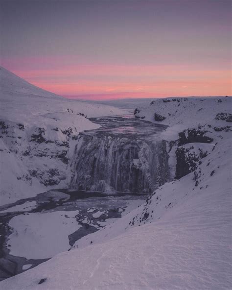 This Incredible Sunset Over A Massive Frozen Waterfall In The Middle Of