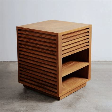 A Wooden Table With Two Shelves On Each Side