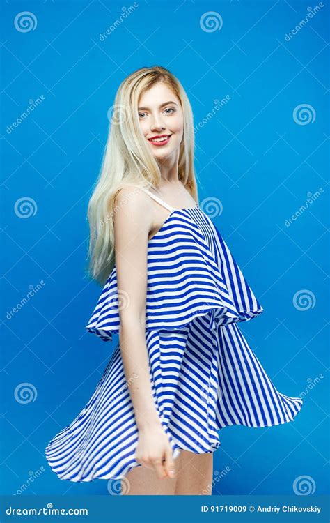 Cute Young Woman Is Posing In Studio Portrait Of Beautiful Blonde