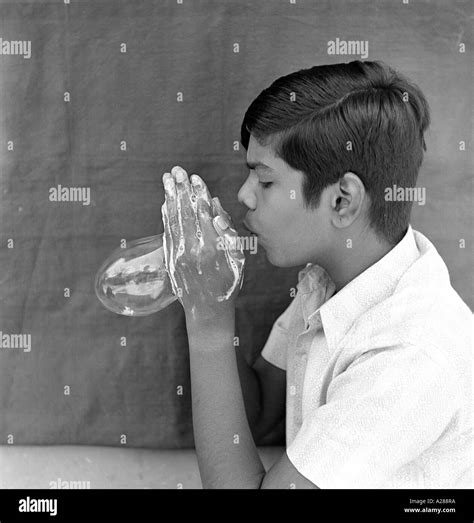 Boy Blowing Soap Bubble Stock Photo Alamy