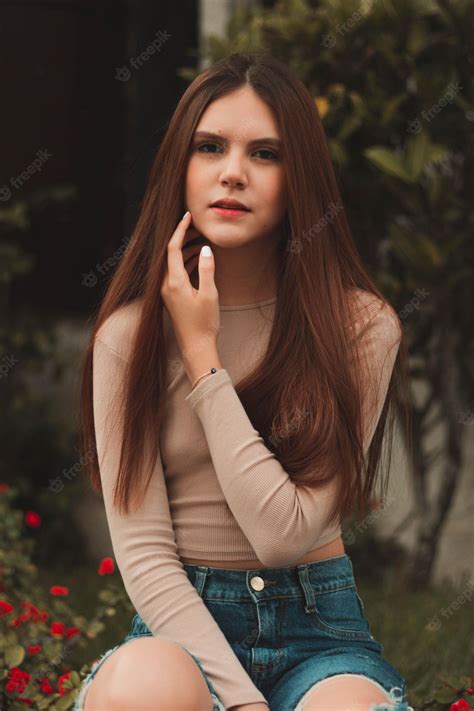 Premium Photo Portrait Of A Beautiful Young Woman Sitting Posing With