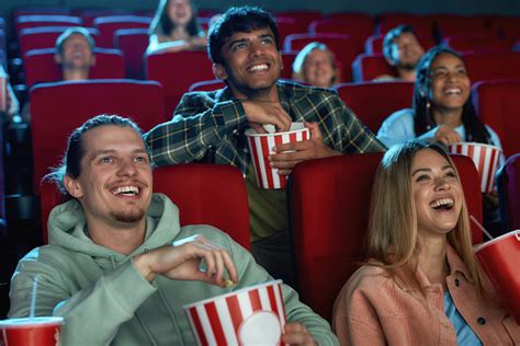 Joyful Diverse People Laughing While Watching Movie Together Sitting In