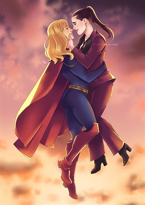 Supergirl In Her New Costume Carrying Lena Luthor In Her Arms As They Smile At Each Other