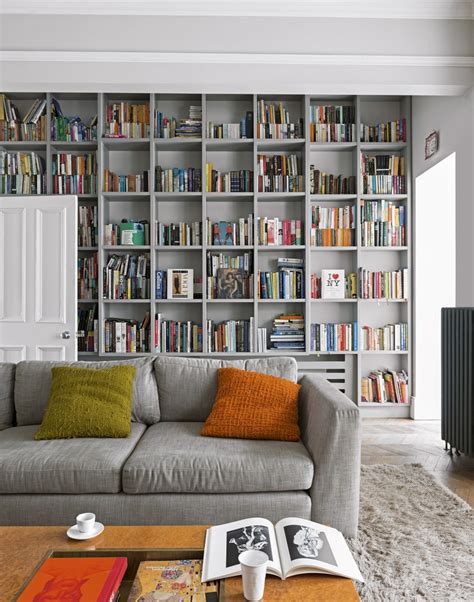 Coloful wall with many books on book shelves in a modern living room blurred, retro interior. Use Paint to Create a Living Room Brimming with Character ...