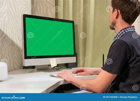 A Man Works In Front Of A Computer With A Green Screen Stock Photo Image Of Technology Blank