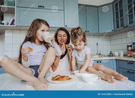 Mom And Two Daughters Eat Pancakes Stock Image Image Of Laughing Daughter 131013683