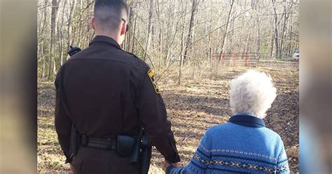 photo captures officer walking 81 year old woman with dementia home hand in hand