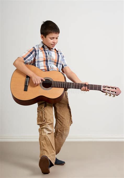 Boy Is Playing The Acoustic Guitar On White Background Stock Image