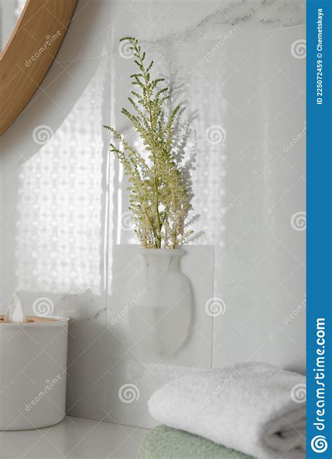 Silicone Vase With Flowers On White Marble Wall Over Countertop Stock