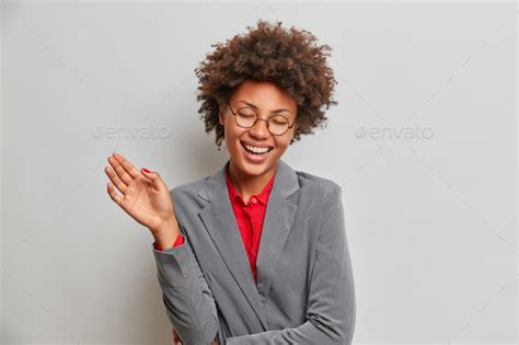 Overjoyed Successful Female Entrepreneur Laughs From Happy Emotions Dressed In Formal Suit