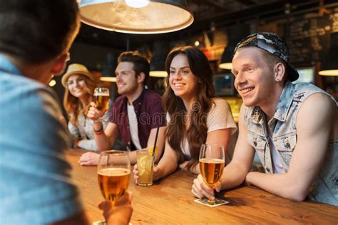 Happy Friends With Drinks Talking At Bar Or Pub Stock Image Image Of
