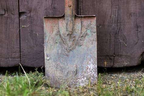 An Old Garden Spade Leaning Against A Wooden Door Tools For Working In