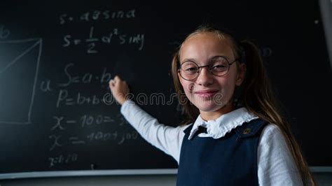 Portrait Of A Caucasian Girl In Glasses In The Classroom The