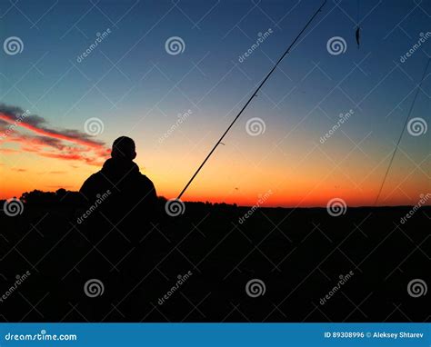 Silhouette Of A Man Fishing At Sunset Stock Photo Image Of Casting