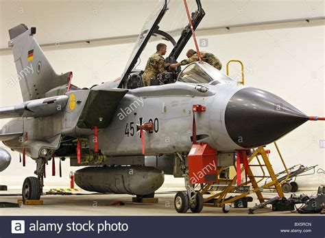 A second helping of tiger paint scheme aircraft: Soldiers of the German Armed Forces repairing a Recce ...