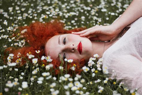 Beautiful Ginger Haired Woman Laying Down On Green Grass By Stocksy Contributor Jovana Rikalo