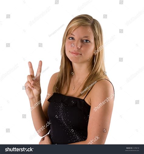 Portrait Of A Beautiful Young Blond Woman In Black Dress Holding Up Two