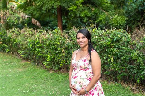 premium photo pregnant latina woman with dress holding her belly