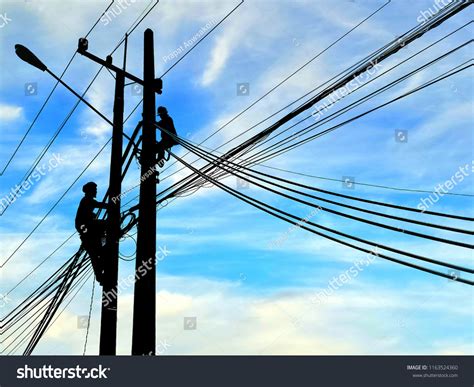 Silhouette Electricians Working Install Cable Lines Stock Photo
