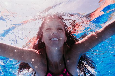 Happy Caucasian Woman Diving In Swimming Pool Underwater View Summer