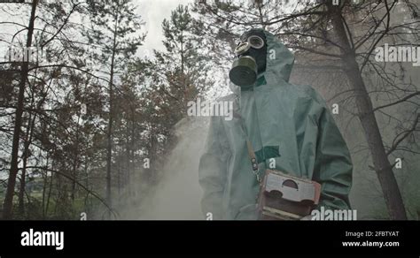 Low Angle Unrecognizable Guy In Hazmat Suit And Gas Mask Looking Around