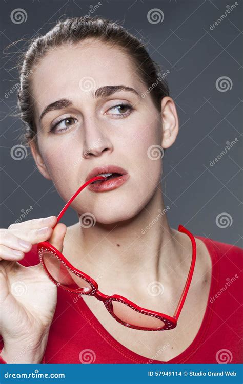 Young Gorgeous Woman Biting Her Fun Glasses In Thinking About Love