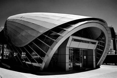 A Black And White Photo Of A Curved Building
