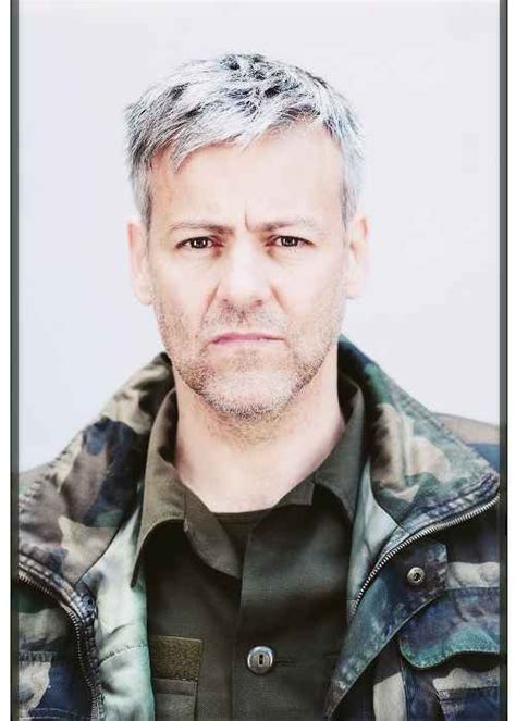 A Man With Grey Hair Wearing A Jacket