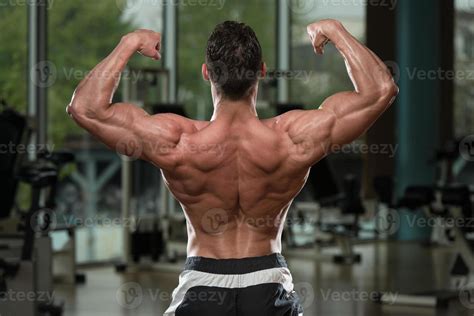 Bodybuilder Performing Rear Double Biceps Pose Stock Photo At