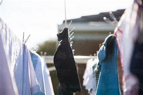 Image Of Clothes Hanging On A Washing Line With Eco Friendly Metal Pegs