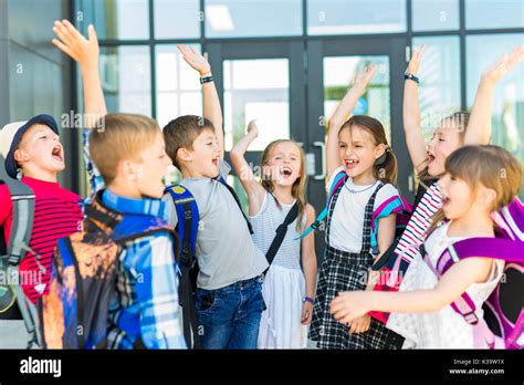 Portrait Of School Pupils Outside Classroom Carrying Bags Stock Photo