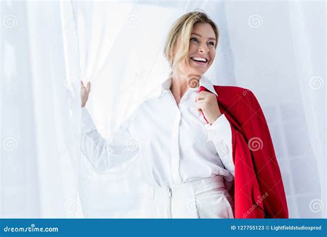 Attractive Businesswoman Holding Red Jacket And Looking Away Stock Image Image Of Mature